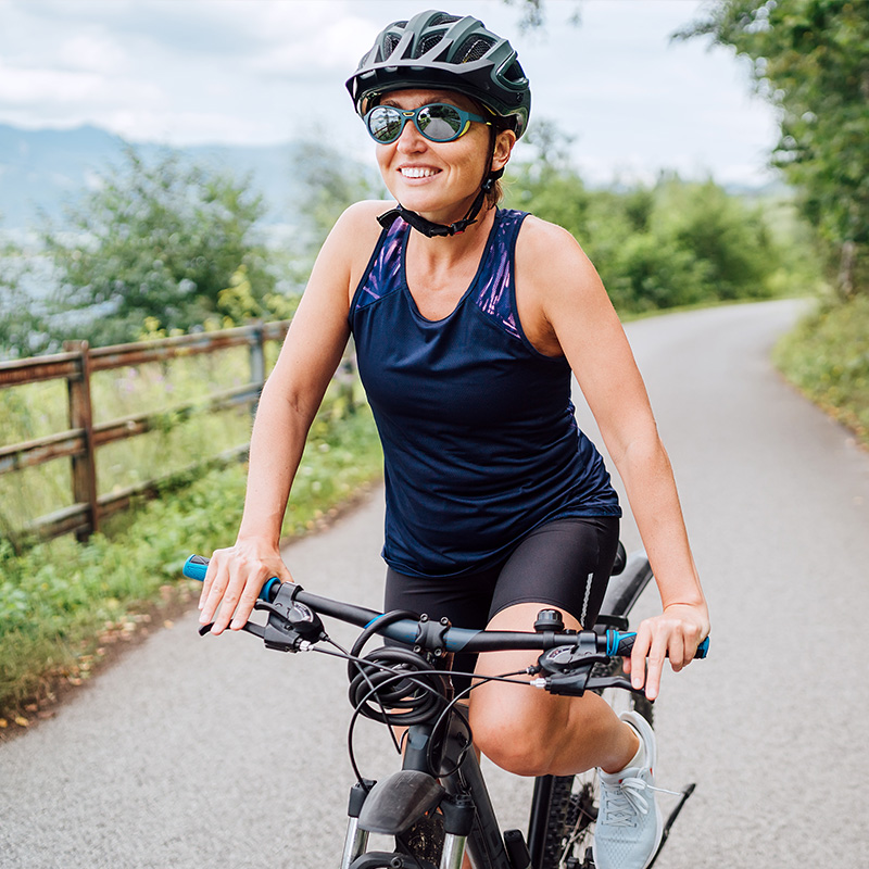 Woman Smiling while Biking