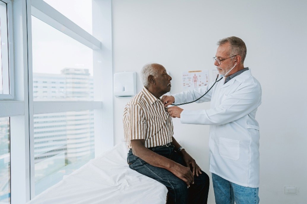 Cardiovascular specialist listening to a patient's heartbeat